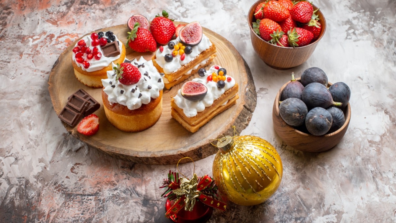 front-view-delicious-cakes-with-fresh-fruits-light-background-christmas-cake-dessert-color-biscuits (1)
