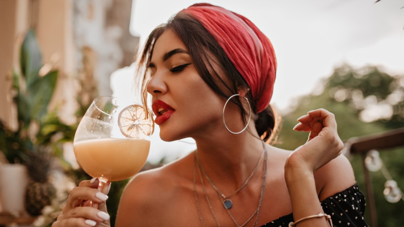 attractive-brunette-haired-girl-with-pink-headband-round-silver-earrings-bright-bandana-black-shirt-drinking-cocktail (1)